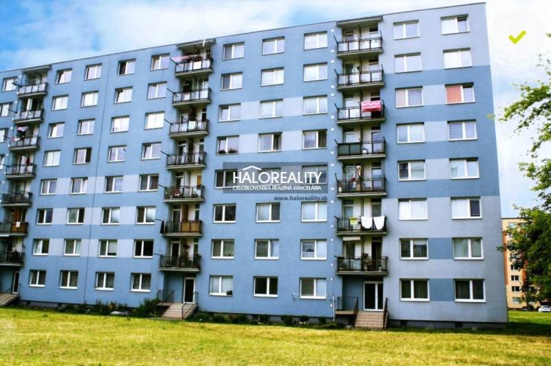 Apartment building with balconies and greenery in Liptovský Mikuláš, suitable for a 2-room apartment.