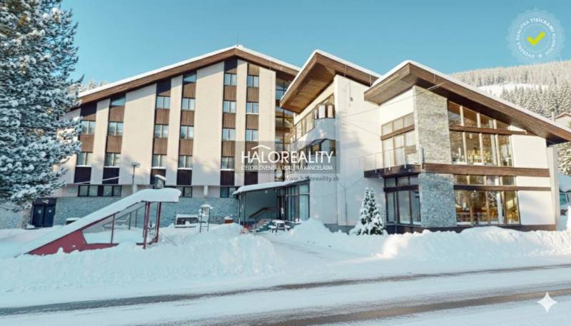 Snow-covered hotel and guesthouse buildings in the village of Vyšná Boca in winter.