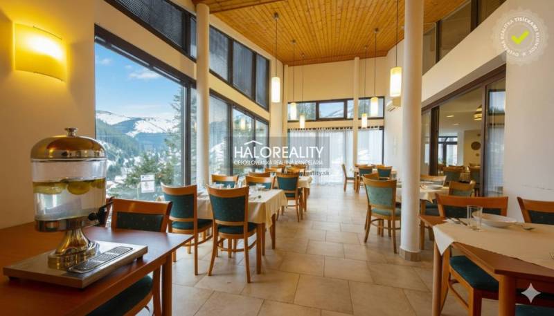 Restaurant in a hotel with a view of snow-covered mountains and set dining.