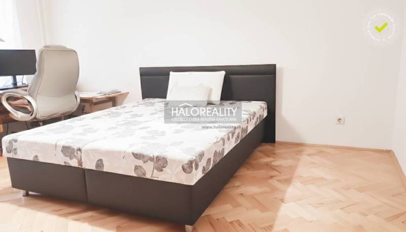 Bedroom in a 3-room apartment with a bed and a desk, floor with wood decor.