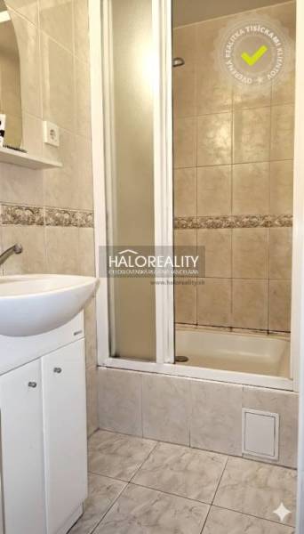 A bathroom with a shower and a sink in a 3-room apartment.