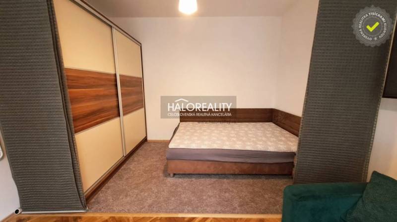 Bedroom with a double bed and a large wardrobe in a studio apartment.