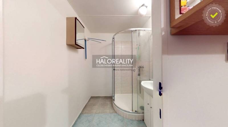 A bathroom in a 3-room apartment with a corner shower and tiles.