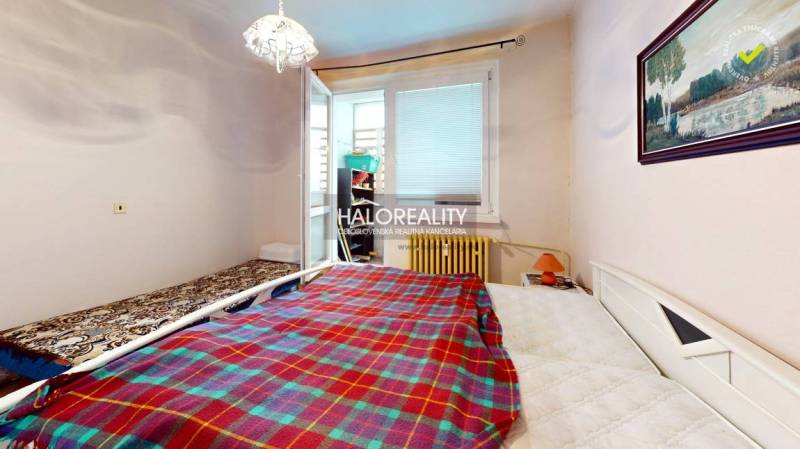 A room in a 3-room apartment with beds, a painting, and access to a balcony.