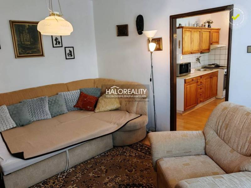 Living room with a sofa, entrance to the kitchen in a 3-room apartment.