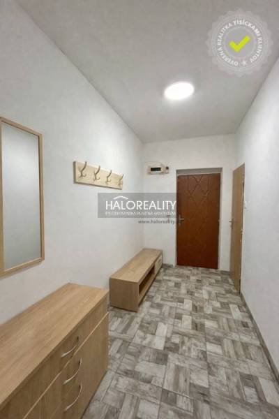 A hallway in a 4-room apartment with tiles and wooden furniture.