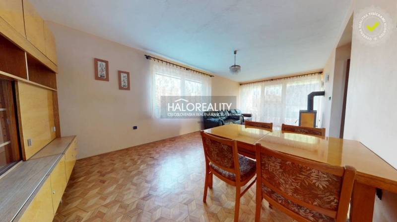 Living room in a family house with a wooden decor floor and a dining table.