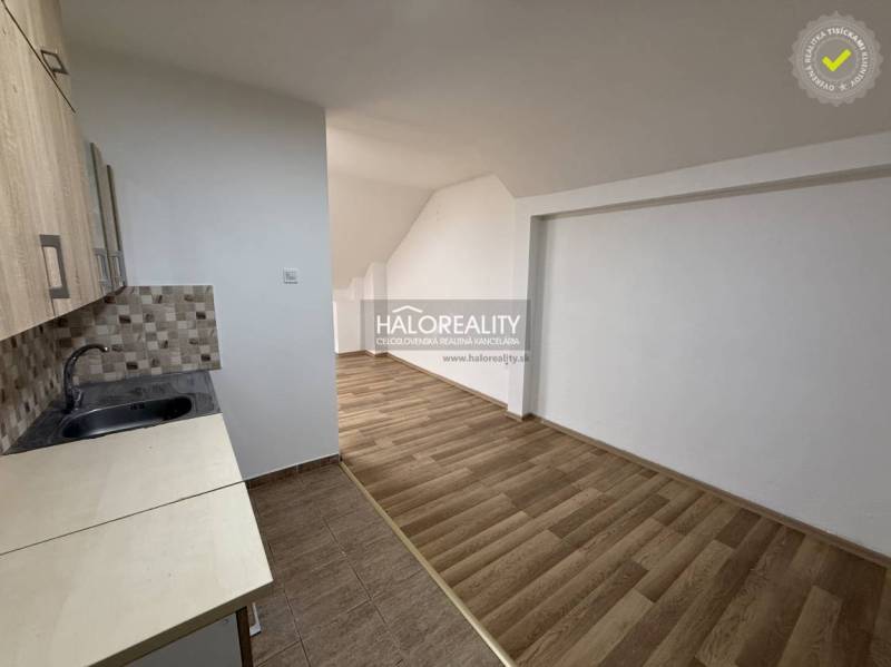 Studio apartment with a kitchenette and a wooden decor floor.