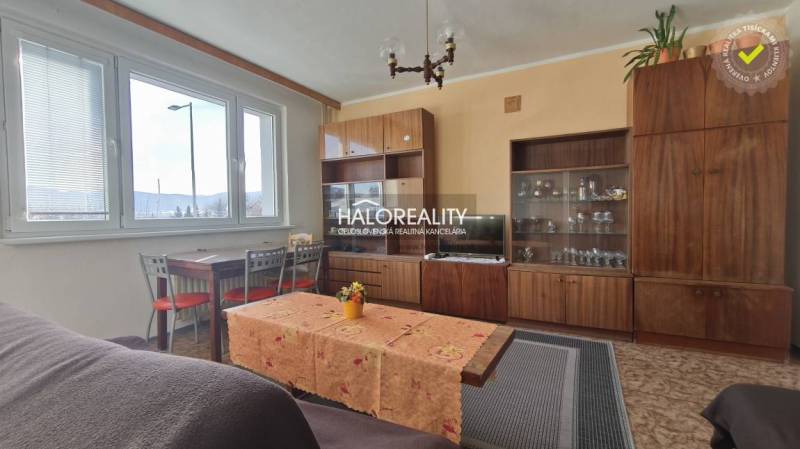 Living room in a 3-room apartment with retro furniture and a large window.