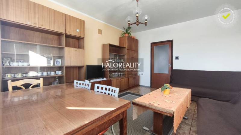 Living room in a 3-room apartment with furniture and ceiling chandelier lighting.