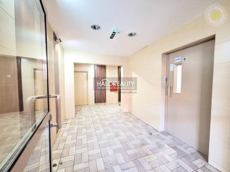 A nice entrance hall with an elevator and bright walls in a 2-room apartment.