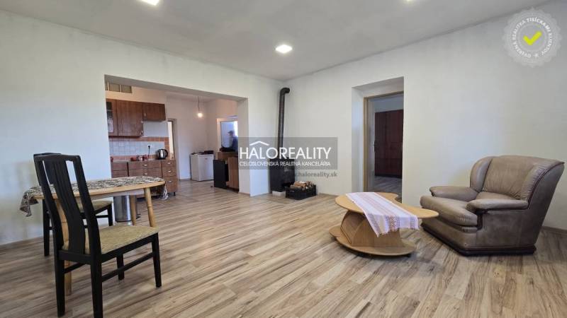Living room in a family house with a wooden decor floor, fireplace, and furniture.