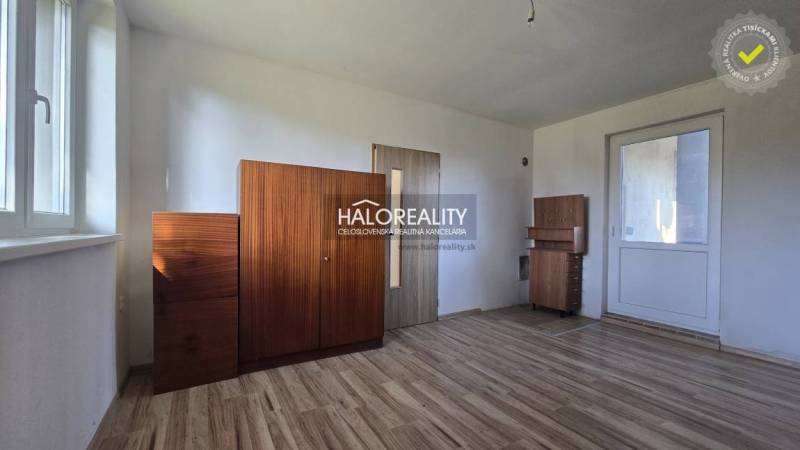 The interior of a family house with a wooden decor floor and wooden cabinets.