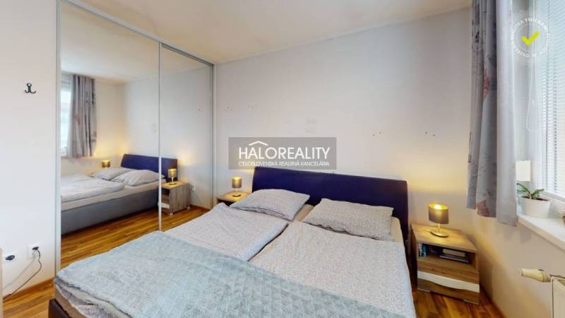 Bedroom with a double bed and a mirrored built-in wardrobe in a 2-room apartment.