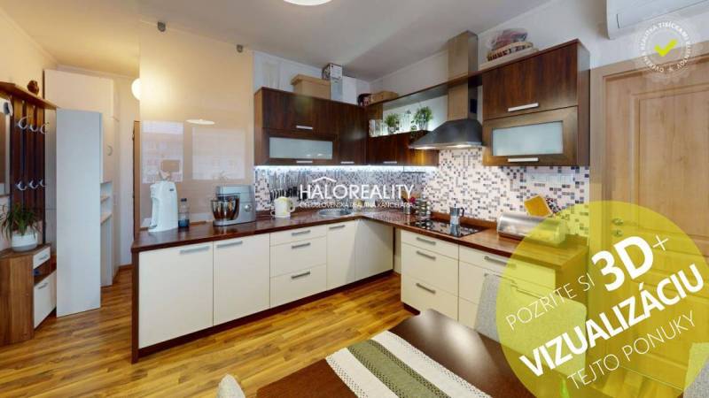 Spacious kitchen in a 2-room apartment with a wooden decor floor and white cabinets.