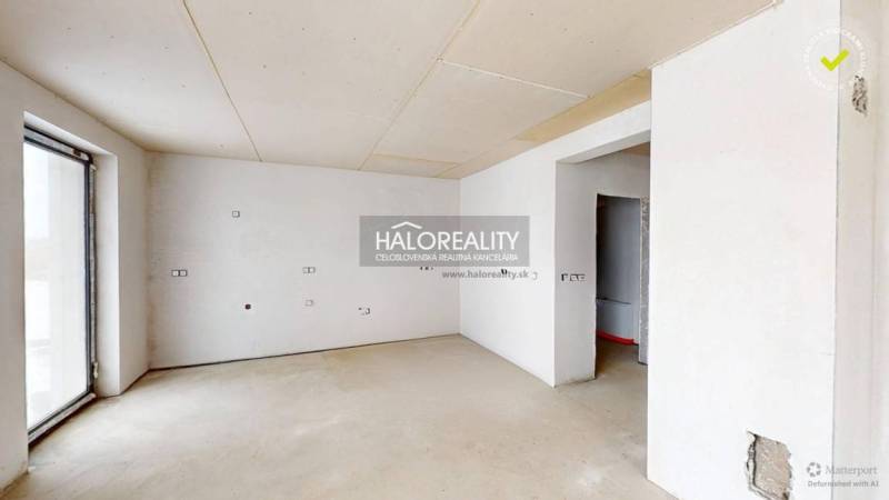 A spacious office with white walls and a large window.