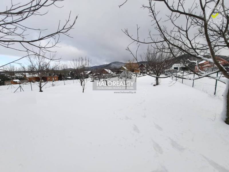 Snow-covered residential plots in Ruská Nová Ves with trees and mountain views.