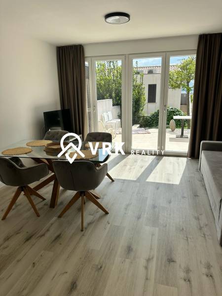 Recreational apartment with glass doors and wooden decor flooring.