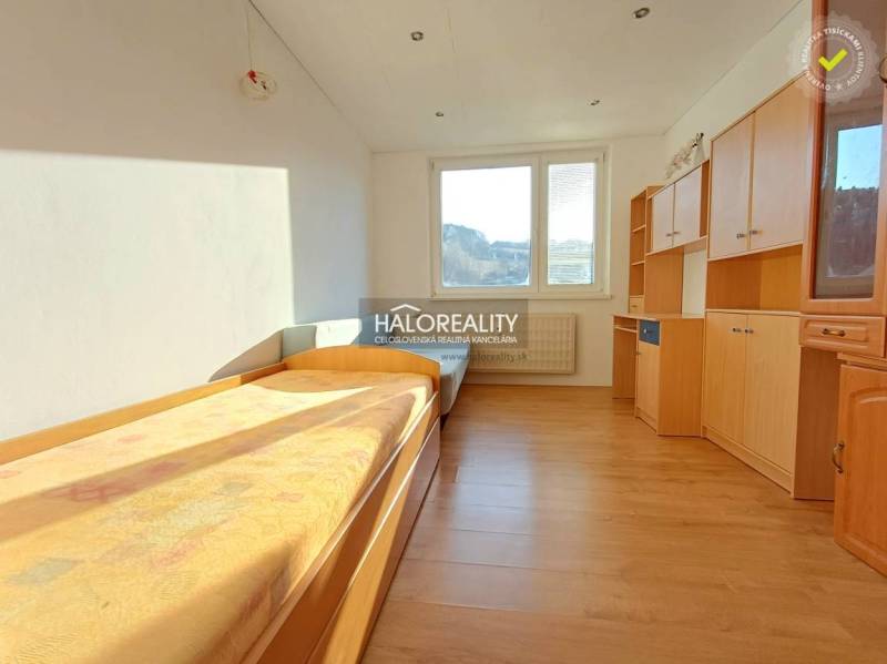 A room in a 3-room apartment with a bed and wardrobes, floor with wood decor.