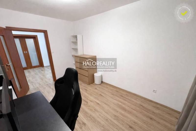 Cozy study room with a desk, chair, and wooden decor flooring in a 3-room apartment.
