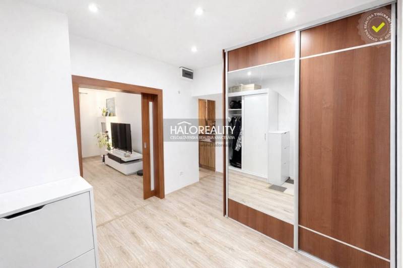 Interior of a 3-room apartment with a wooden decor floor and a built-in wardrobe.