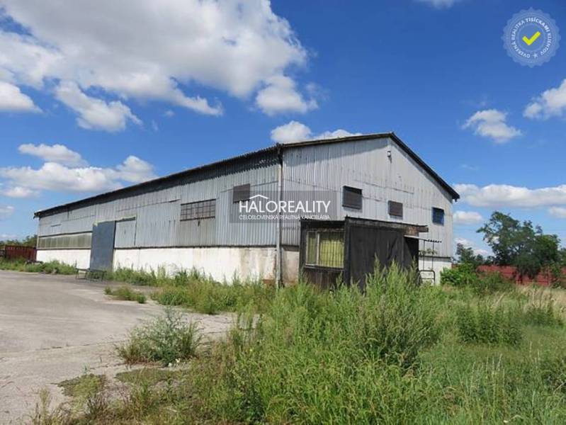 Warehouses and halls in Hurbanova Ves with metal structures and lush vegetation.