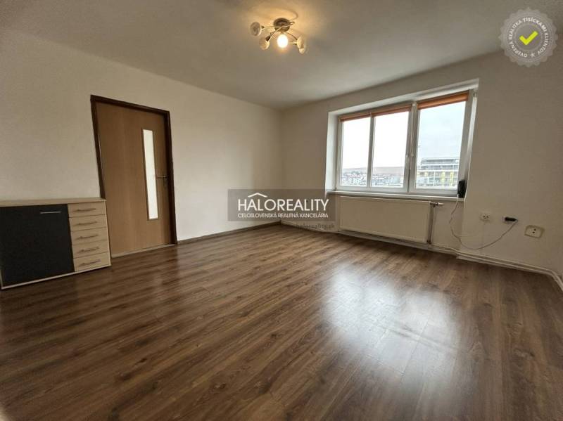 A room in a 2-room apartment with a floor featuring a wooden decor and light.