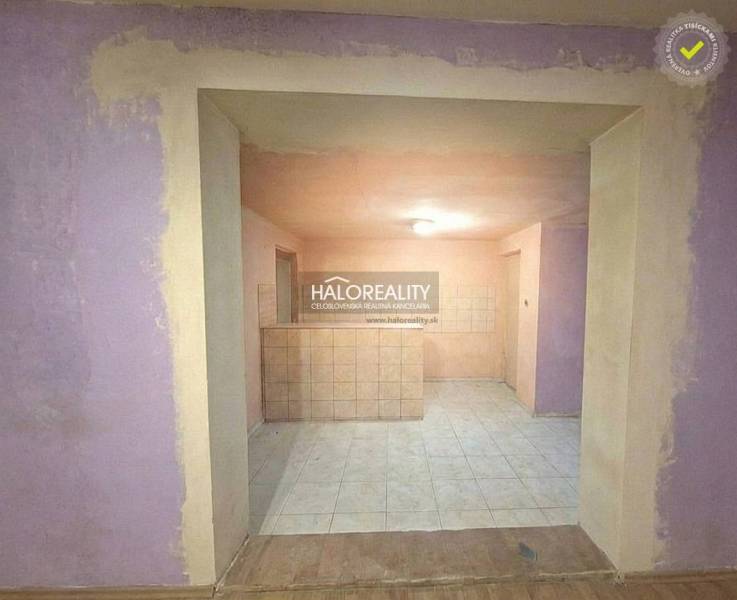 The interior of a family house with tiled flooring and purple walls.