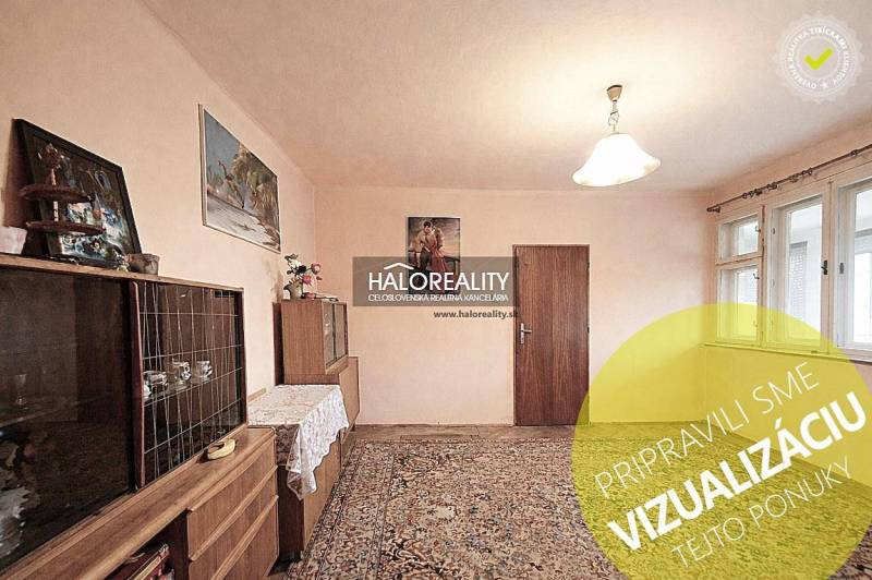 Interior in a family house with furniture, carpet, and paintings on the walls.