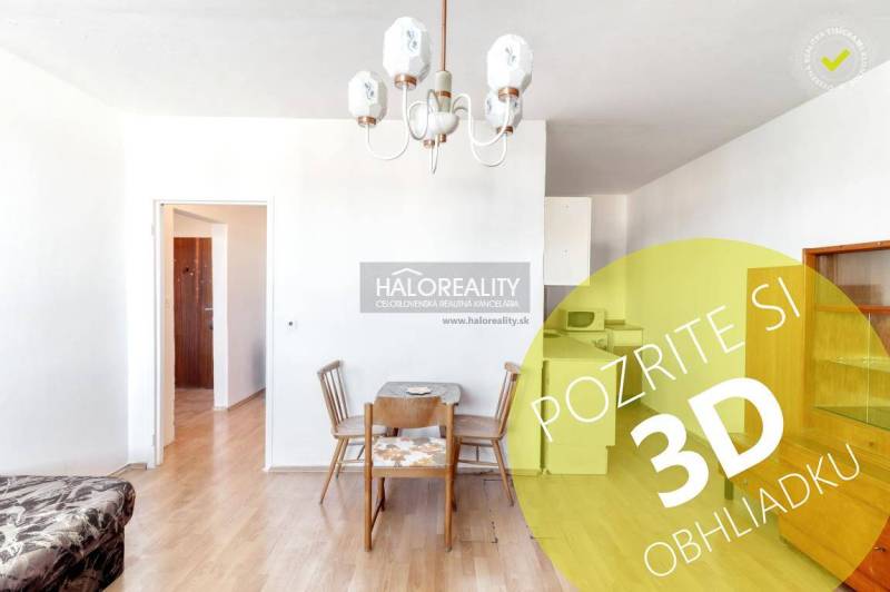 Dining table and chairs in a 2-room apartment with a wooden decor floor.