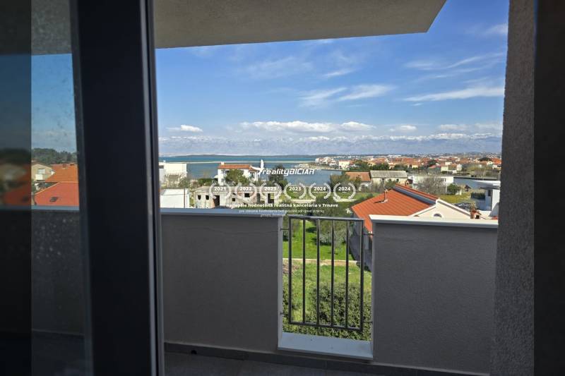 The view from a holiday apartment in Nin of the Adriatic Sea and surrounding houses.
