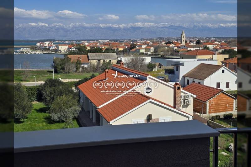 The view from the holiday apartment in Nin captures the rooftops of houses and the nearby sea.