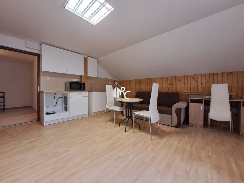 A cozy apartment with a kitchen, wooden decor flooring, and a dining table in a 3-room flat.