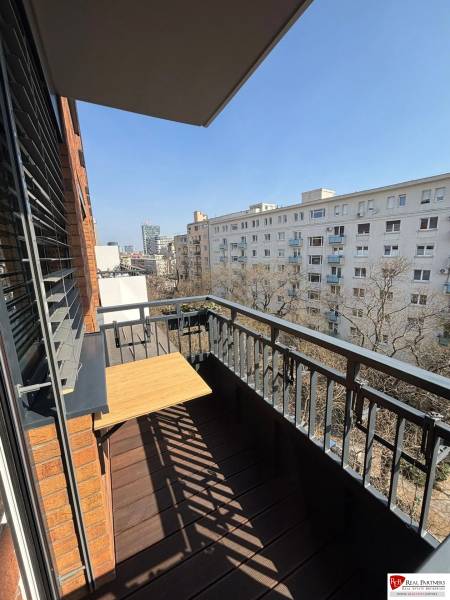 The balcony of a 3-room apartment on Bernolákova Street in Bratislava - Old Town with a wooden decor.
