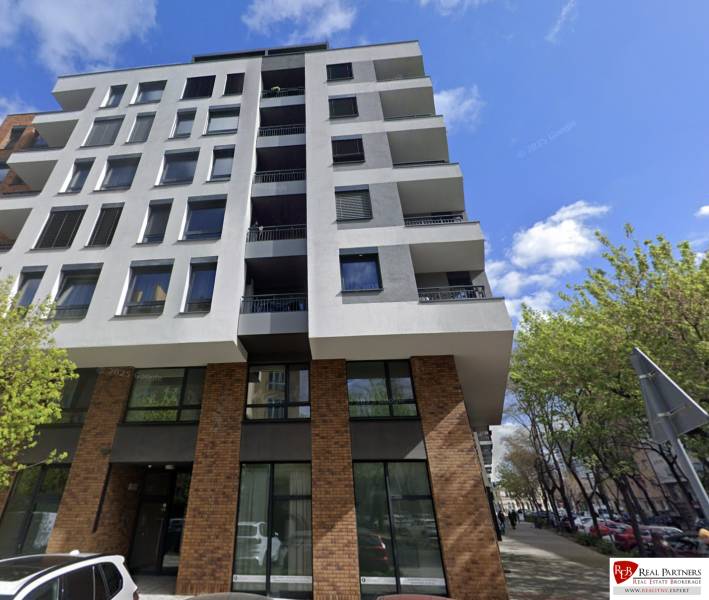 A five-story building on Bernolákova Street in Bratislava - Staré Mesto surrounded by trees.