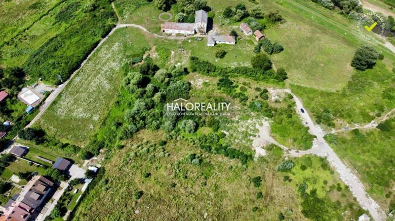 An aerial view of residential plots in Tornaľa surrounded by greenery.