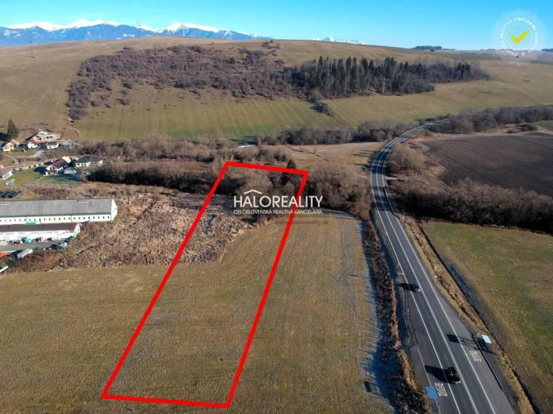 A residential plot in Gôtovany next to the main road with a view of the mountains.