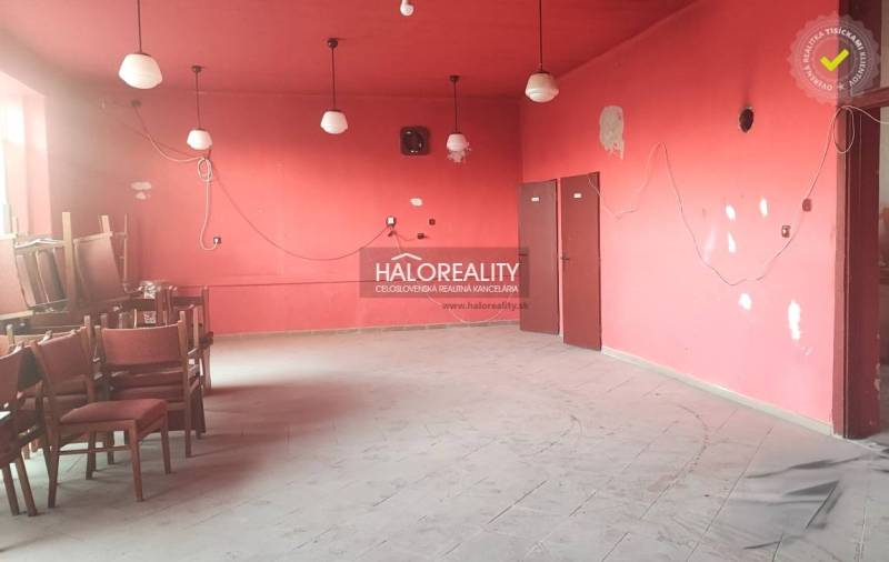 Empty, red commercial spaces with chairs and floor tiles, five light fixtures visible.