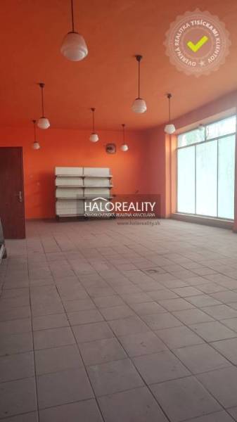 Commercial space with light orange walls, tiled floor, and six light fixtures.