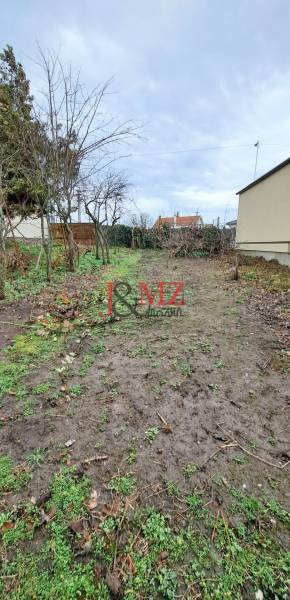 A garden with grass and trees in the section for Residential Land in Levice.