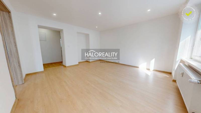 A room with a wooden floor decor in a two-room apartment. Light through a large window.