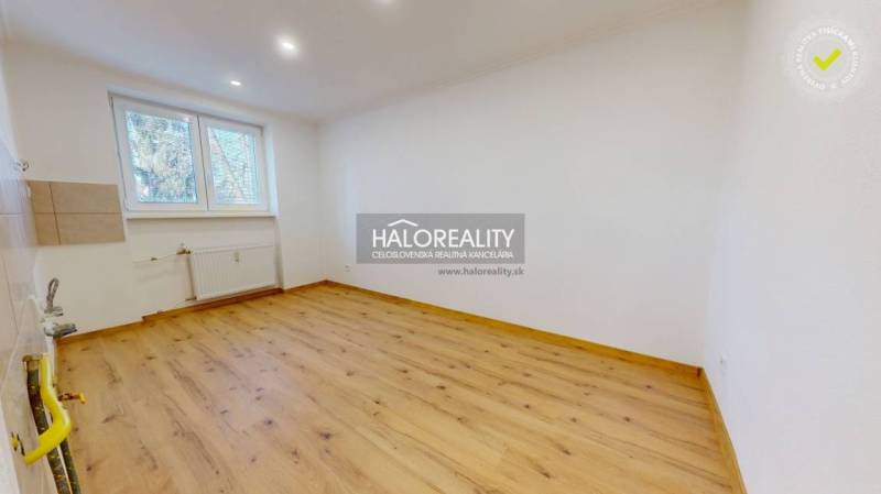 An empty room with a wooden decor floor in a two-room apartment, bright space.