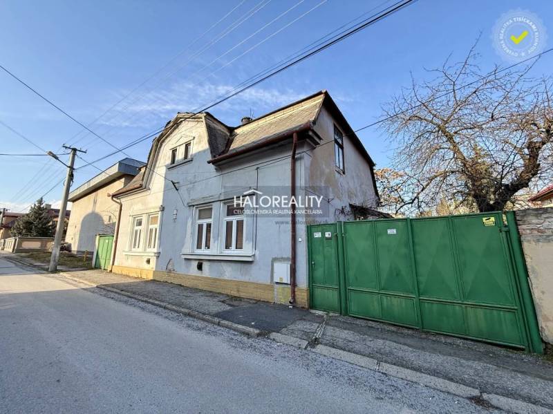 A family house in Rimavská Sobota with a gate and facade on a quiet street.