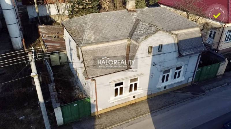 A family house in Rimavská Sobota with a white facade and a pitched roof.