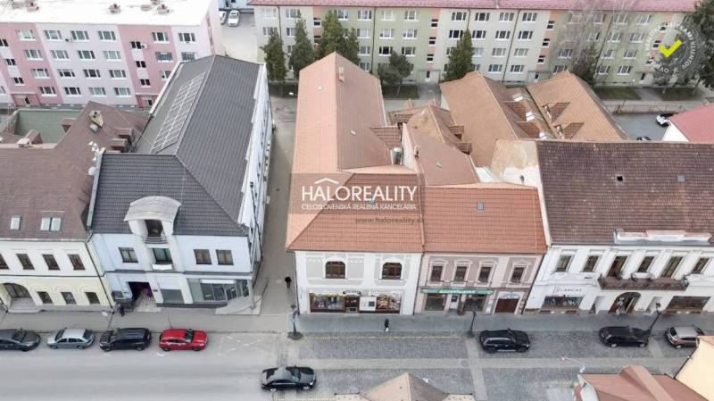 Commercial premises in Rimavská Sobota with historic buildings and cars on the street.