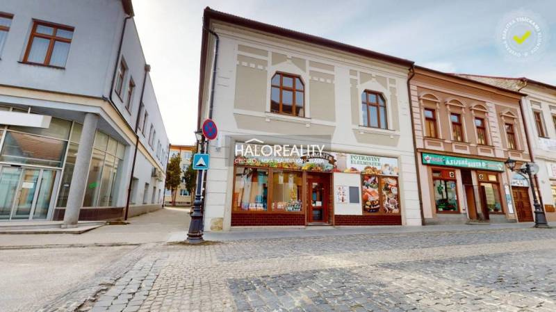 Commercial premises in Rimavská Sobota with an ancient facade and stone paving.