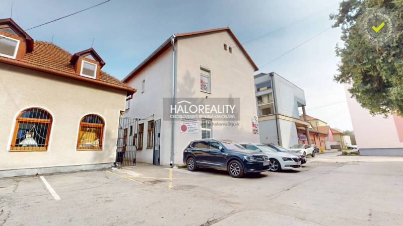 Commercial premises in Rimavská Sobota with parked cars and an access road.