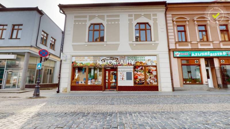 Commercial premises in Rimavská Sobota, facade with signs and pedestrian zone.