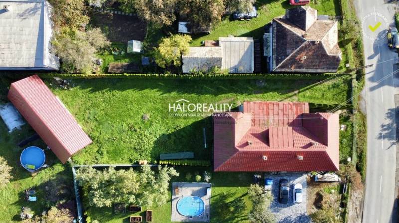 A family house in Hrachovo with a red roof and a green garden, pools, and a gazebo.
