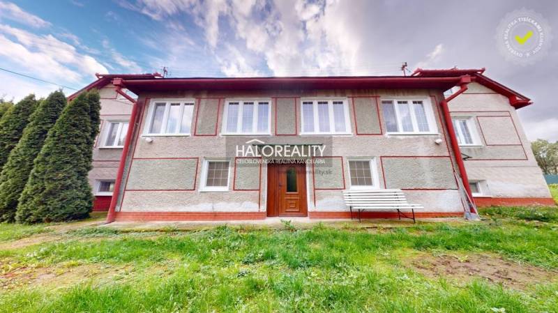 A family house in Hrachovo with a nice green lawn and white shutters.